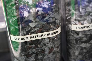 Two jars of lithium battery shred and plastic