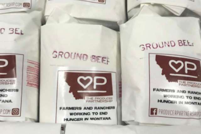 Packages of ground beef with labels from The Producer Partnership, promoting local farmers and ranchers in Montana.
