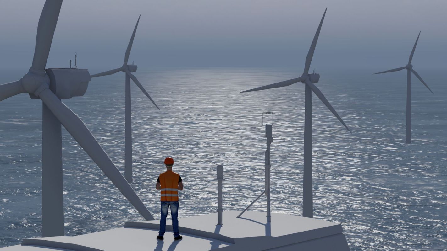 An offshore wind engineer stands on a platform near multiple wind turbines in the water