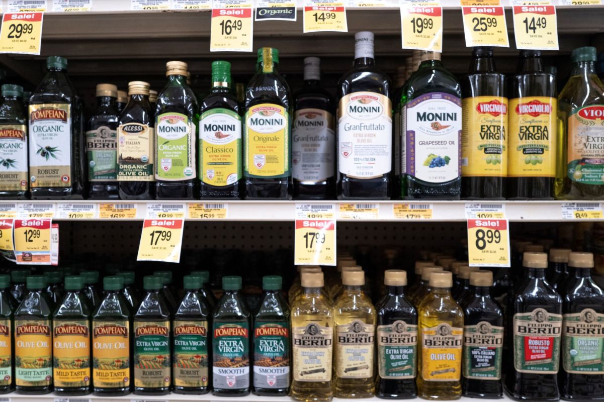 Shelves of olive oil in a grocery store
