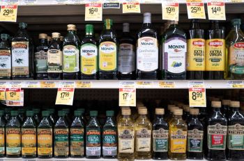 Shelves of olive oil in a grocery store
