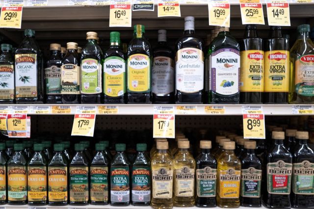 Shelves of olive oil in a grocery store