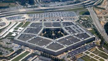 An aerial view of the Pentagon surrounded by parking lots and roadways.