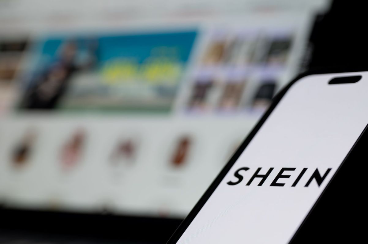 A Shein logo on a smartphone.