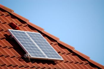 Single solar panel on a roof top