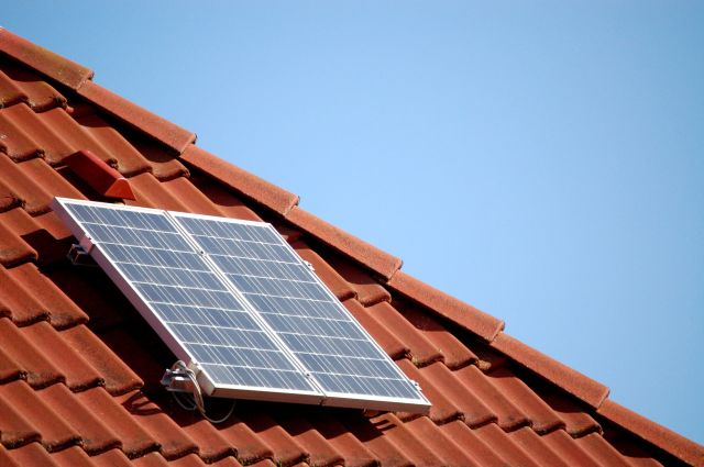 Single solar panel on a roof top