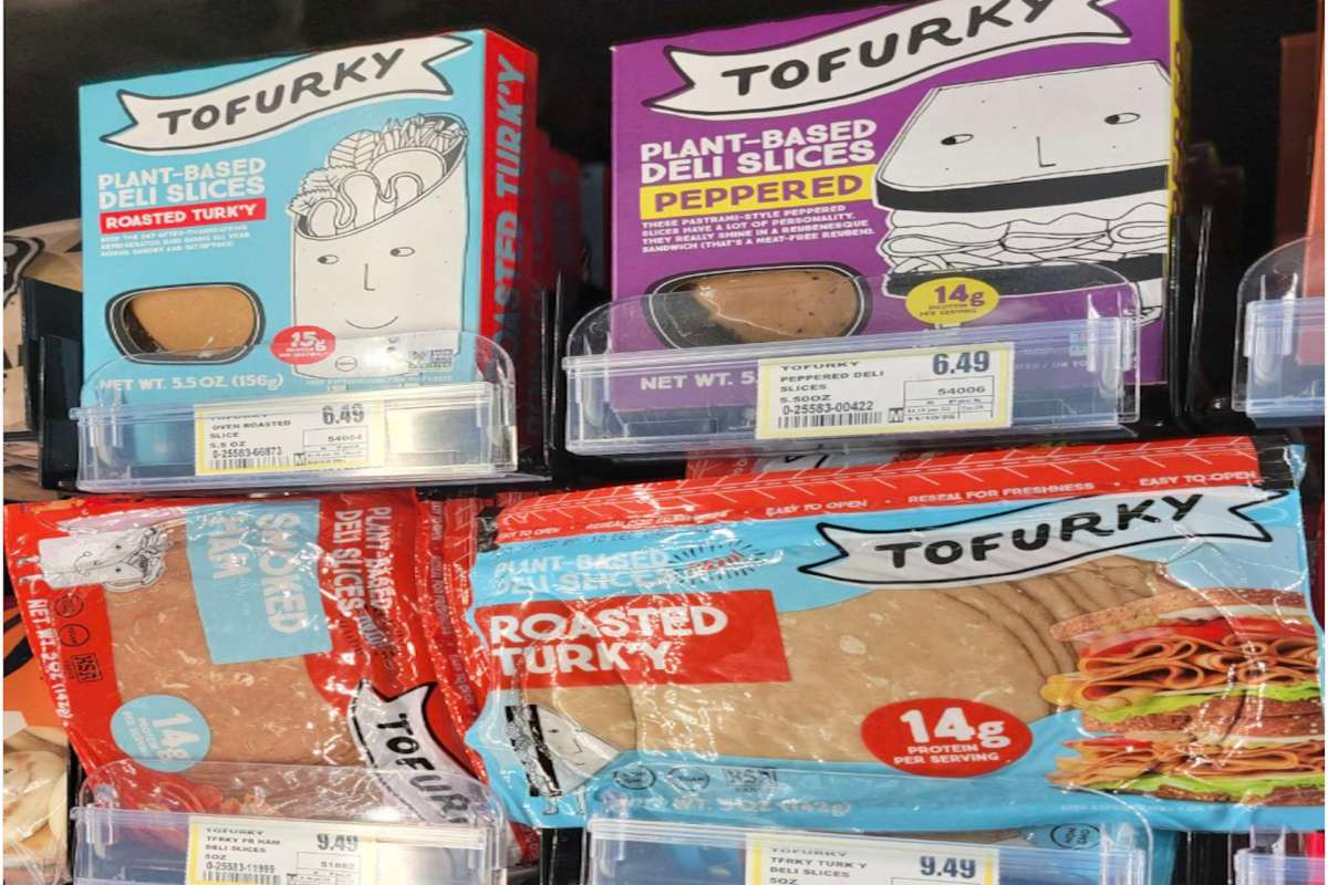 Various packages of Tofurky plant-based deli slices in a grocery store display.