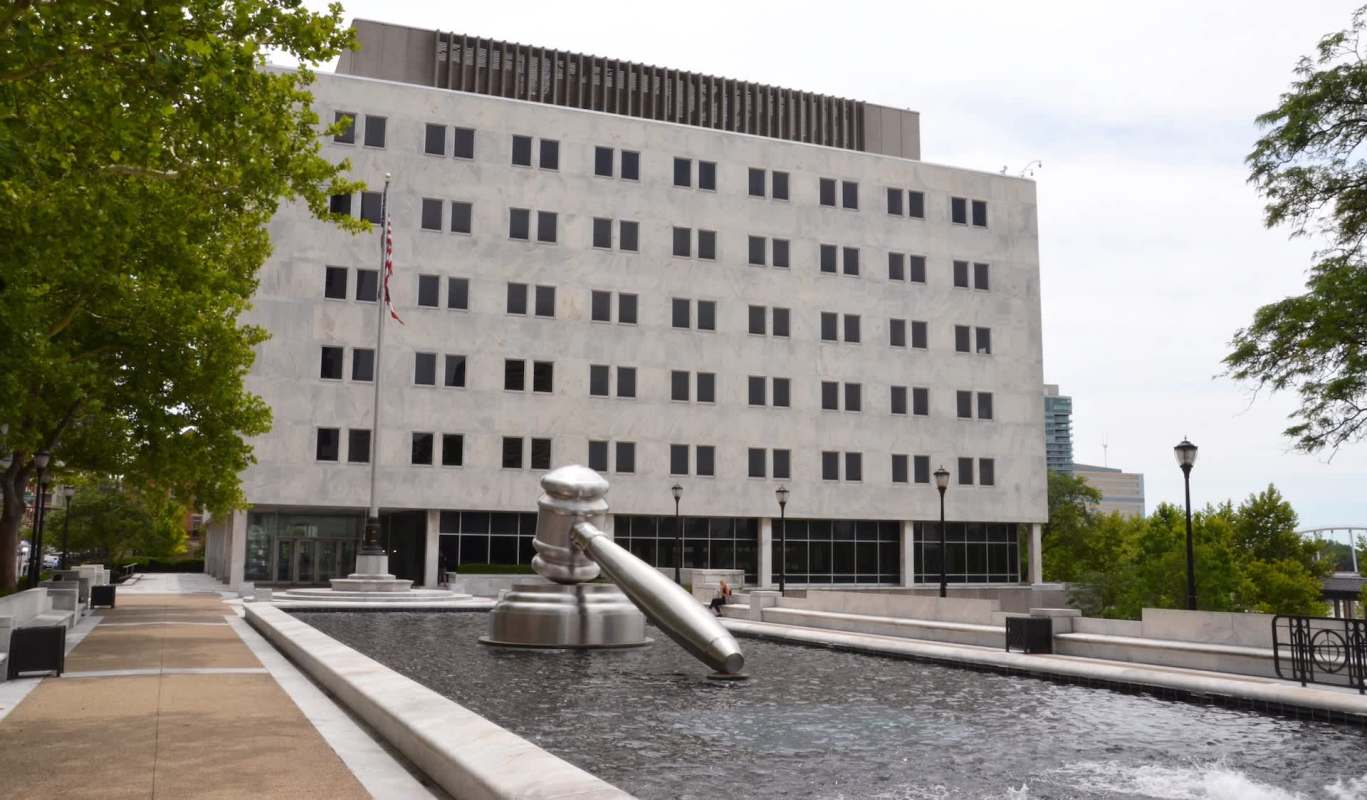 The Supreme Court of Ohio building, with a gavel statue in a pool in the front.