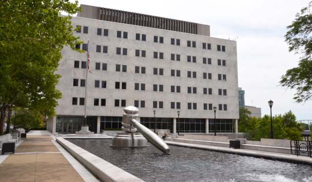 The Supreme Court of Ohio building, with a gavel statue in a pool in the front.