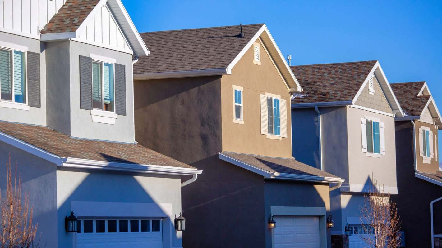 A row of modern houses with various exterior colors and architectural details.