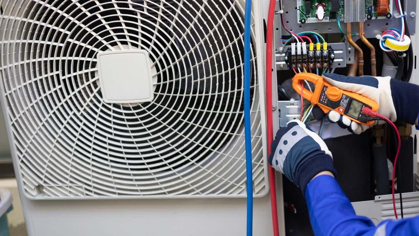 A person working on an air conditioner.