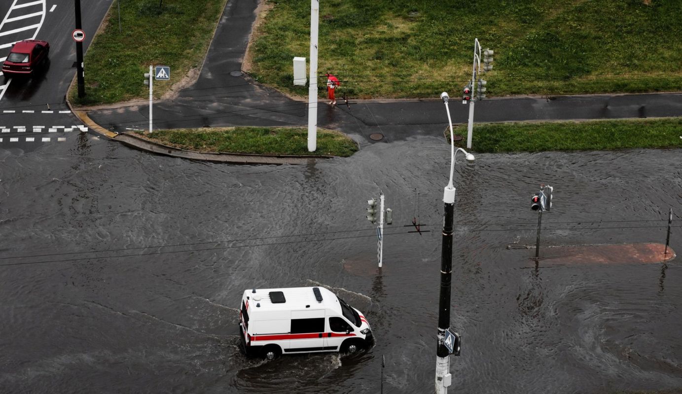 An ambulance on a flooded road.