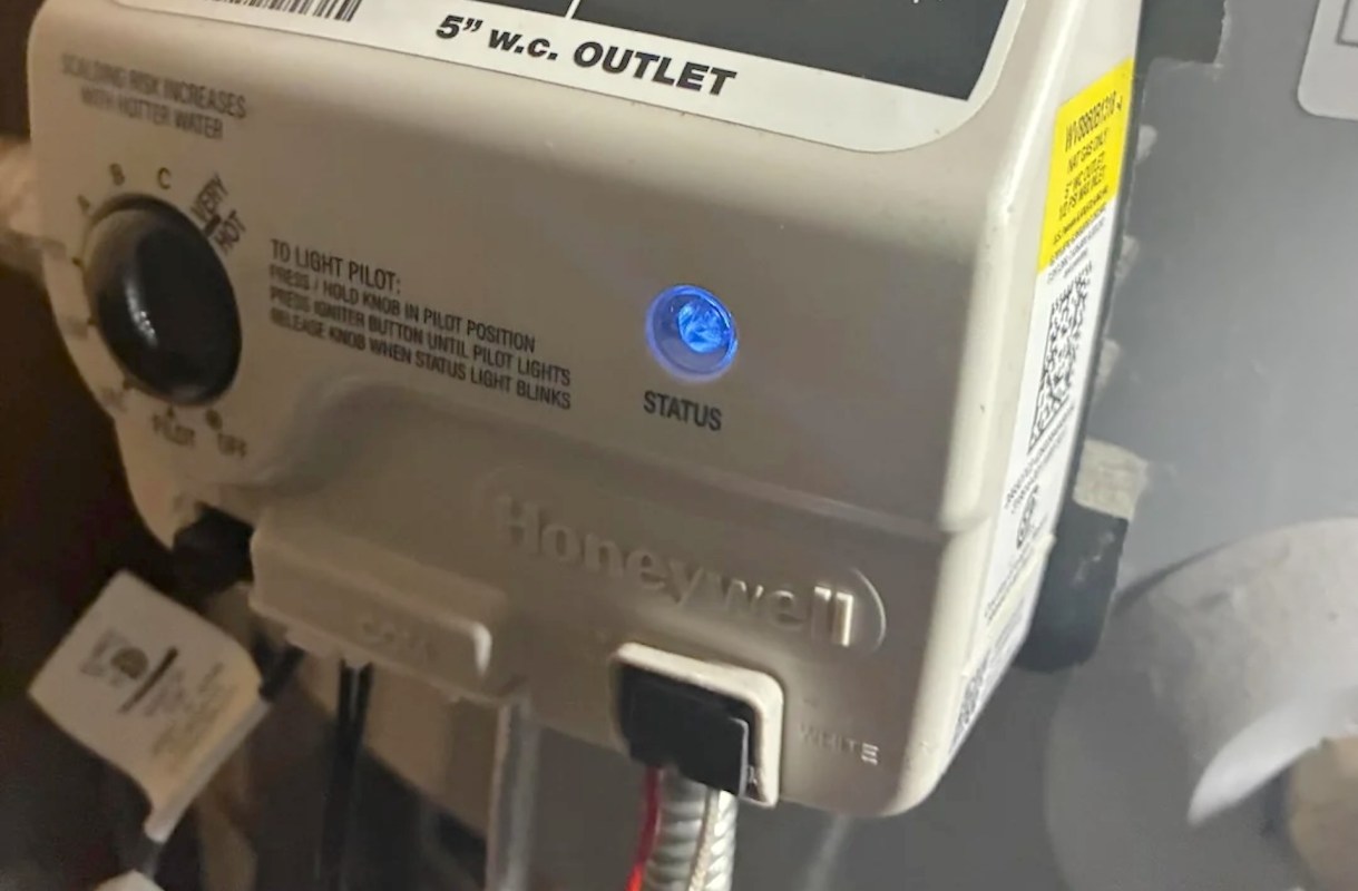 A Honeywell gas control valve prominently displaying a status light and operational instructions.