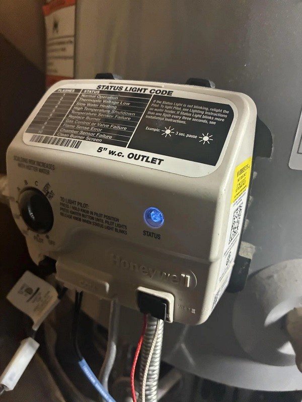 A Honeywell gas control valve prominently displaying a status light and operational instructions.