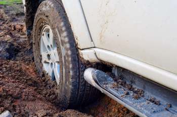 A truck tire stuck in the mud