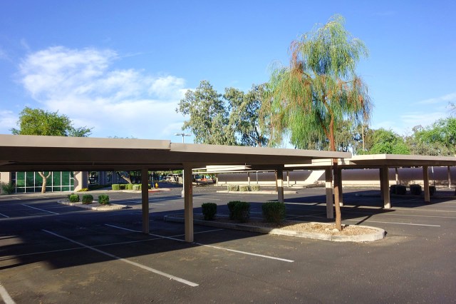 A partially shaded parking lot.