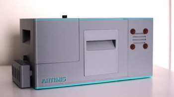 A gray electronic device with a slot and various controls labeled "ARTIMIS."