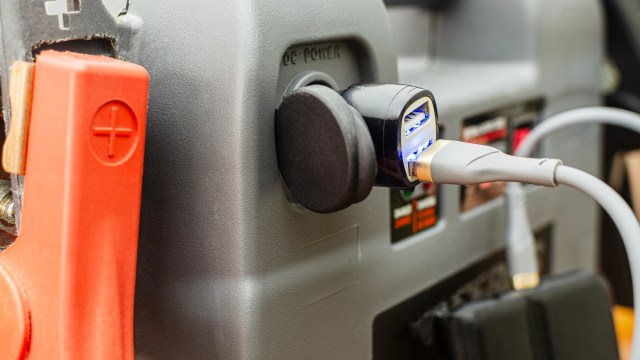 A USB charger is connected to a power outlet in a device.