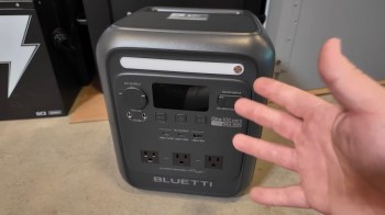 A portable power station with multiple output ports and a digital display.