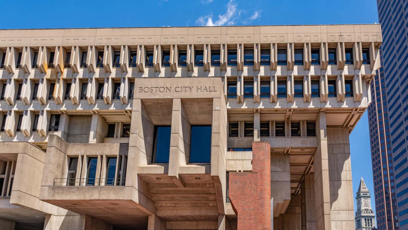 Boston City Hall building with a modern architectural design and blue sky in the background.