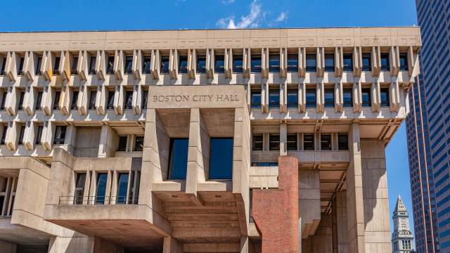 Boston City Hall building with a modern architectural design and blue sky in the background.