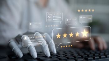 A robotic hand interacts with a keyboard while glowing review ratings and comments are displayed.