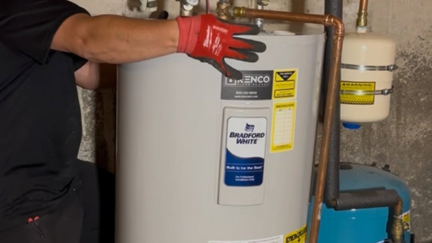 A person in red gloves adjusts a water heater in a basement.
