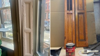 A window with a wooden frame on the left and pre-stained wooden shutters with paint supplies on the right.