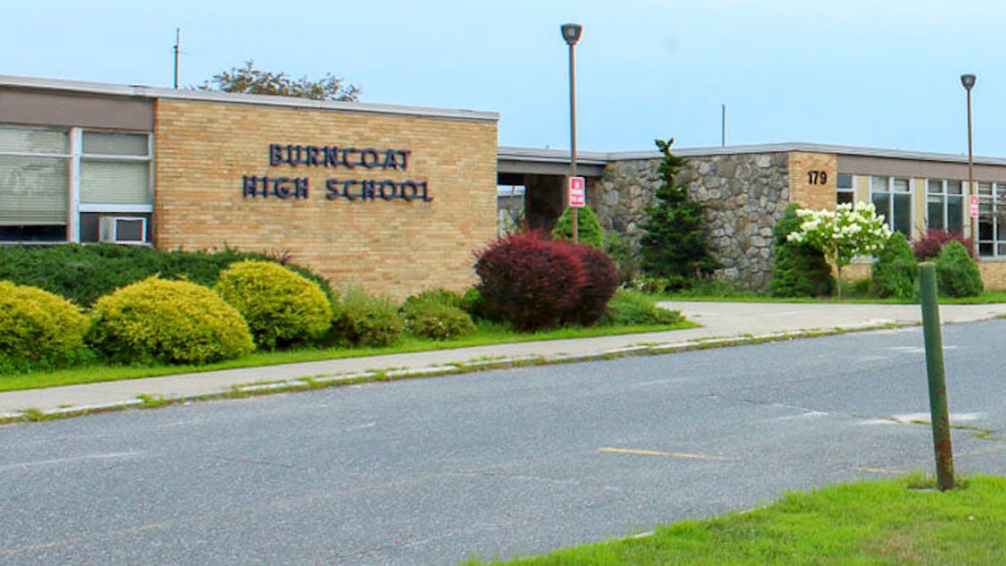 Burncoat High School building with landscaped greenery in the foreground.