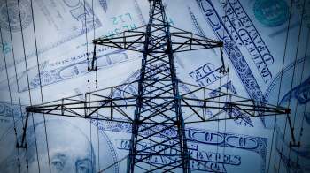 A power line tower silhouetted against a background of hundred-dollar bills.