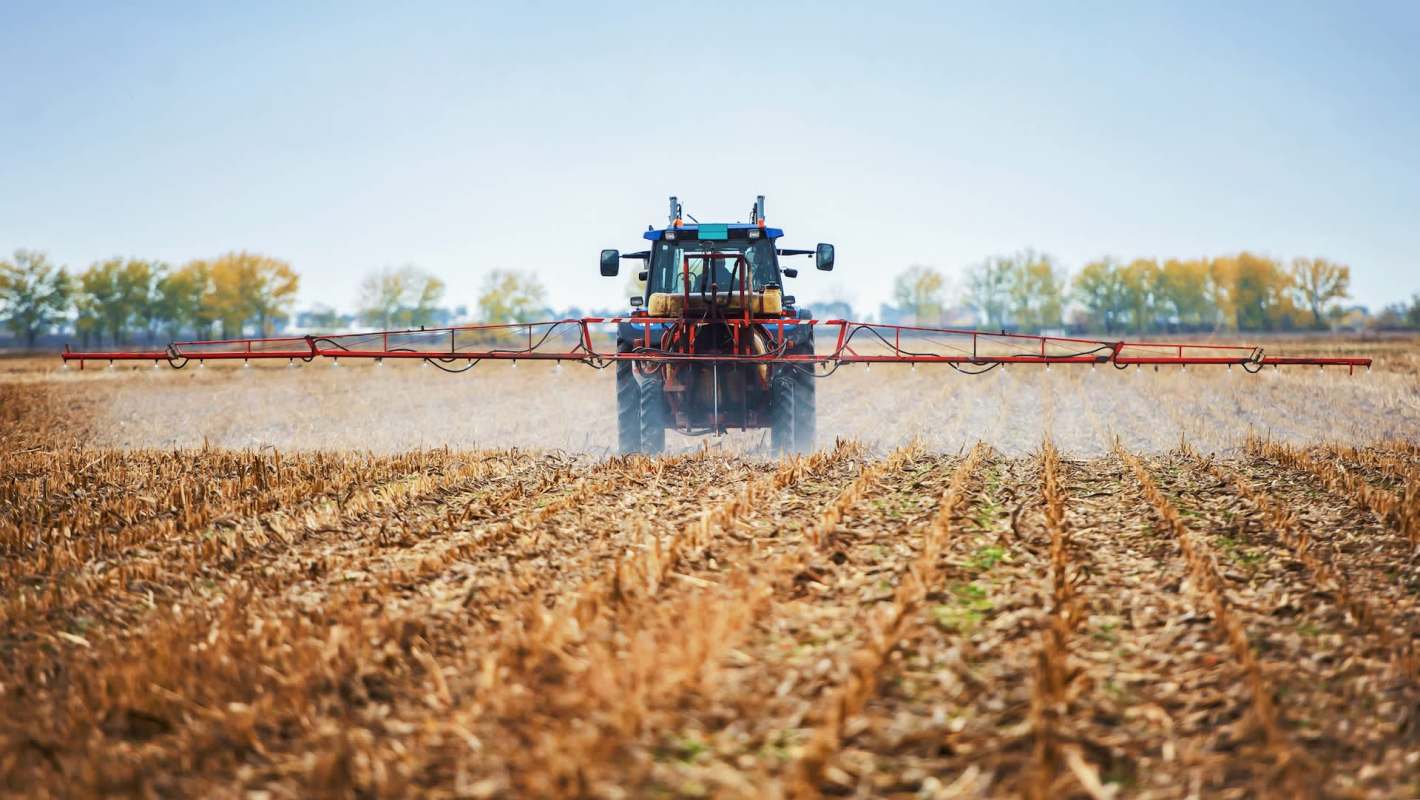 A tractor spraying crops.
