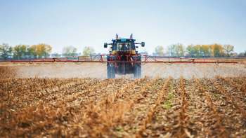 A tractor spraying crops.