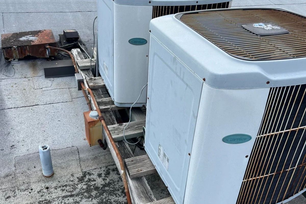 Two Carrier heat pump units on a roof.