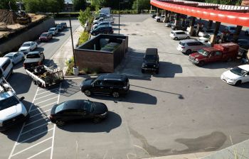Cars lined up at a gas station.