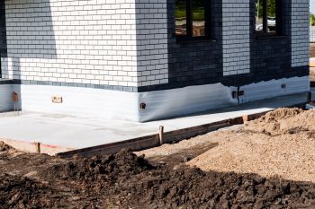 New concrete surrounding a new house.