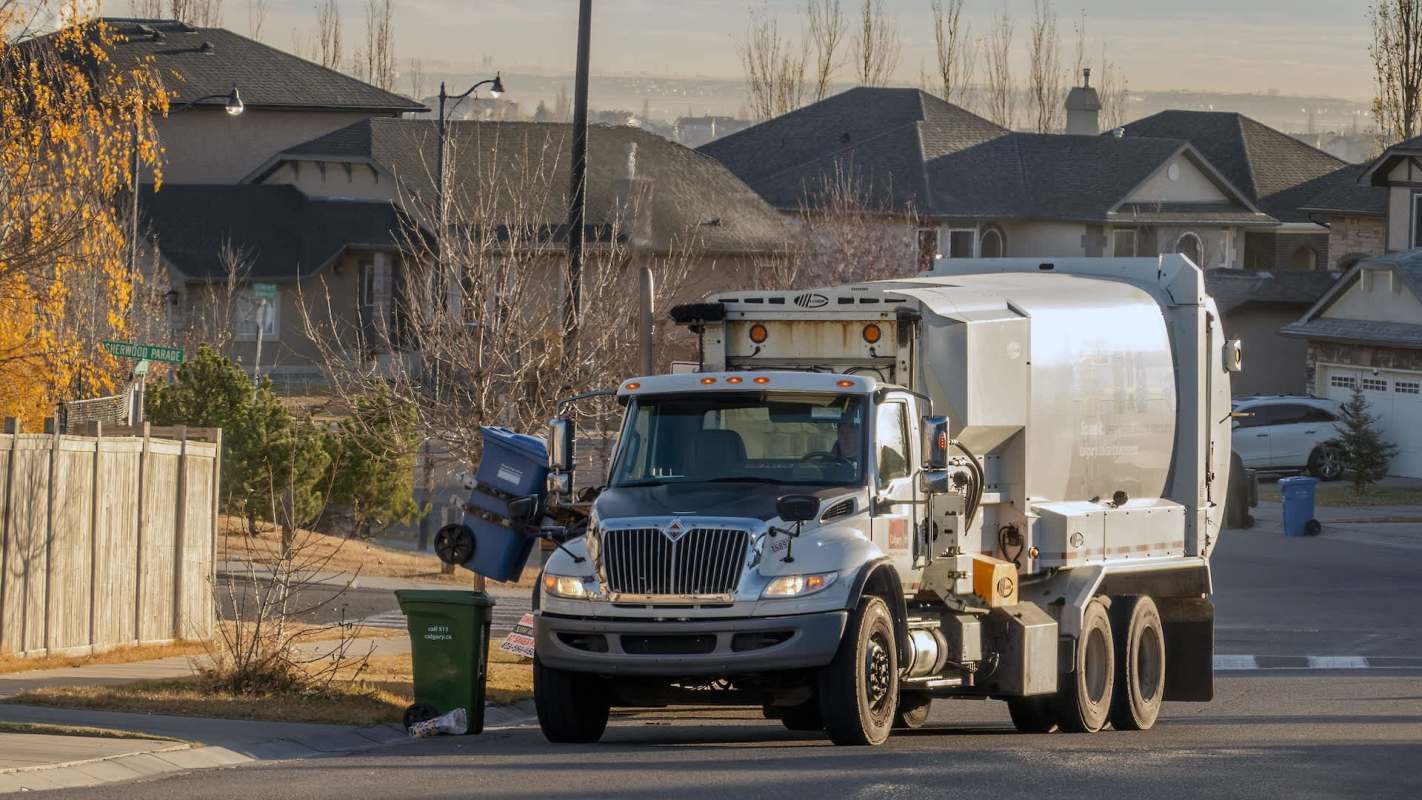 A garbage truck collecting trash.