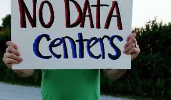 A person holding a sign that reads "NO DATA Centers."