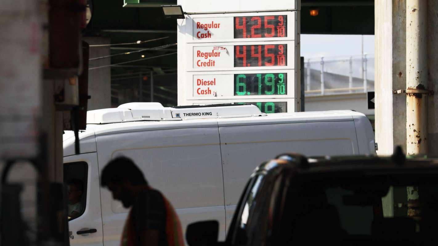 A gas station sign displaying fuel prices for regular and diesel fuel.