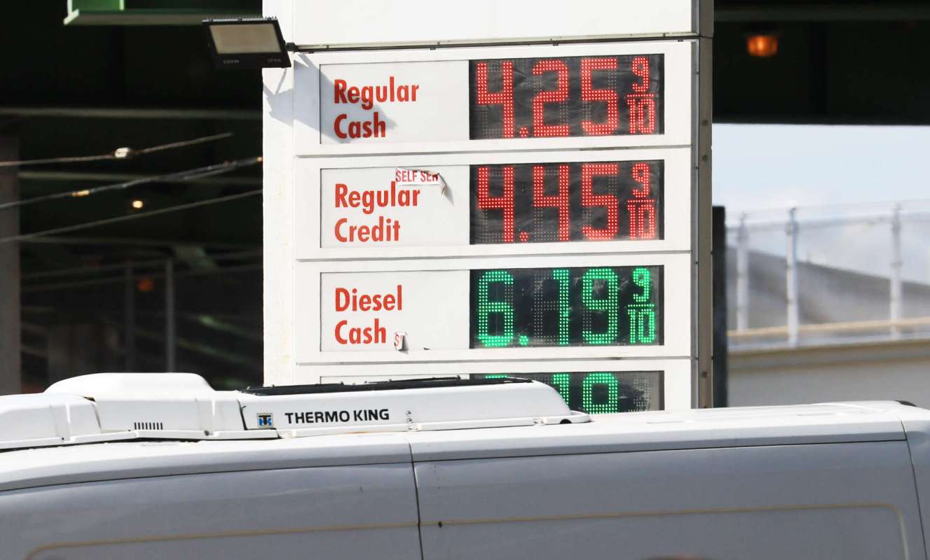 A gas station price sign displaying fuel prices for regular cash, regular credit, and diesel cash.