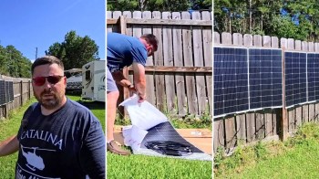 A man unpacks solar panels in a backyard with a wooden fence and an RV in the background.