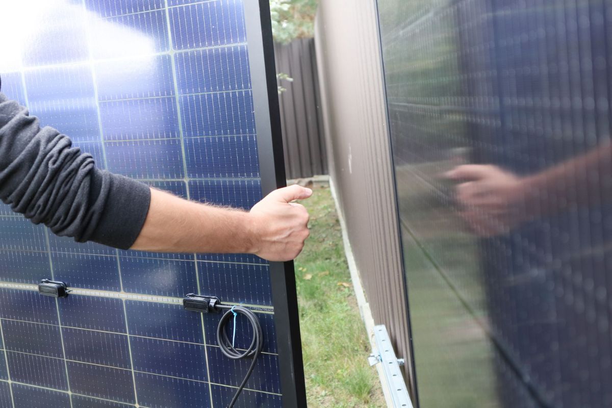 A person holding a solar panel.