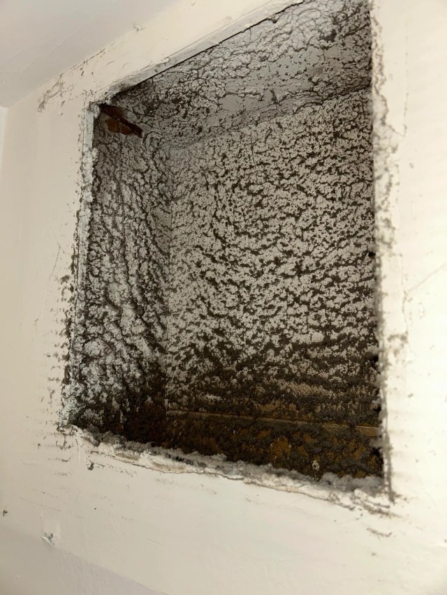 A hole in the wall for an HVAC filter.