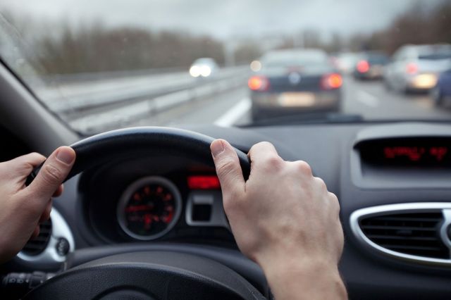 A person driving a car.