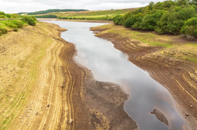 A drought-stricken river with a sandy bank.