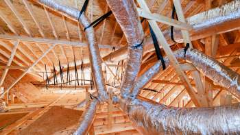 Ductwork and wooden framing inside a building under construction.