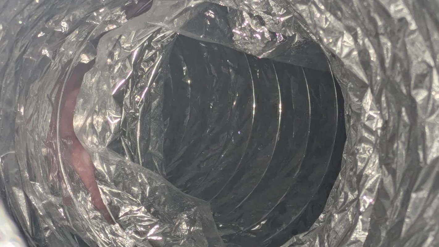 A circular duct with a metallic, crinkled texture.