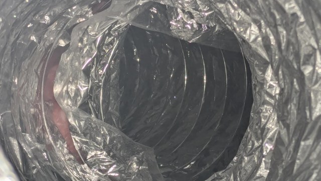 A circular duct with a metallic, crinkled texture.