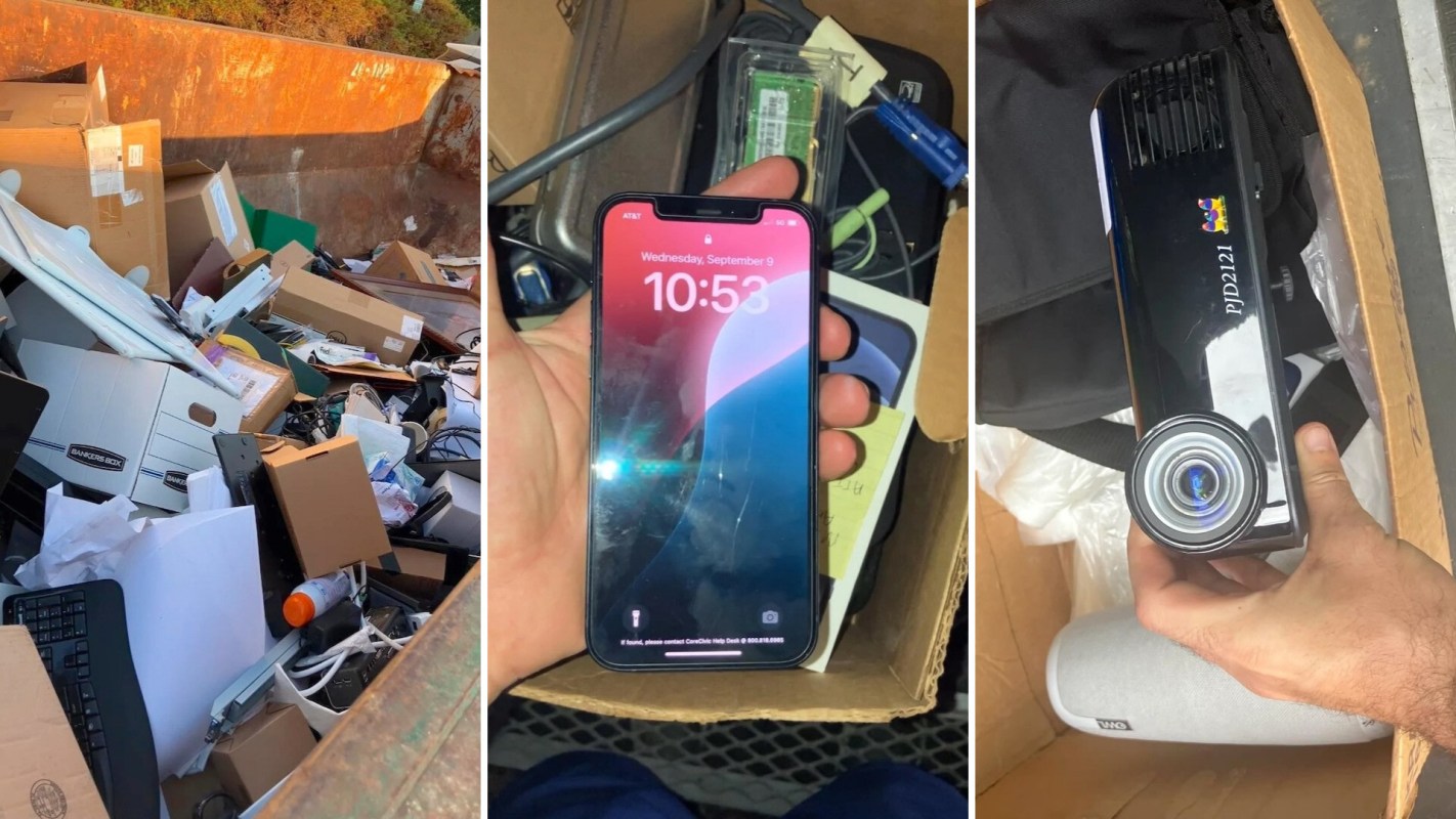 A collection of discarded items in a dumpster, including boxes, electronics, and an iPhone.