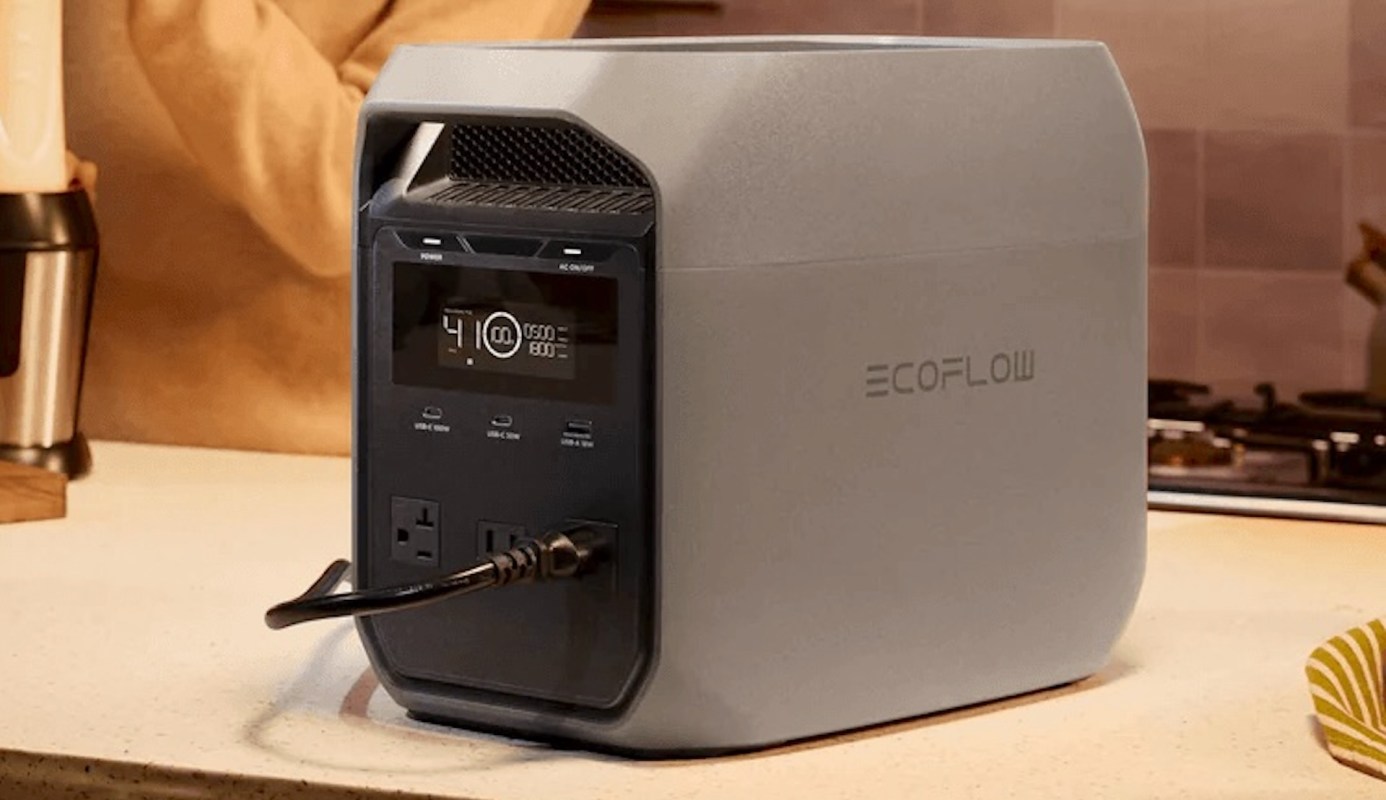 A portable power station with multiple output ports on a kitchen counter.