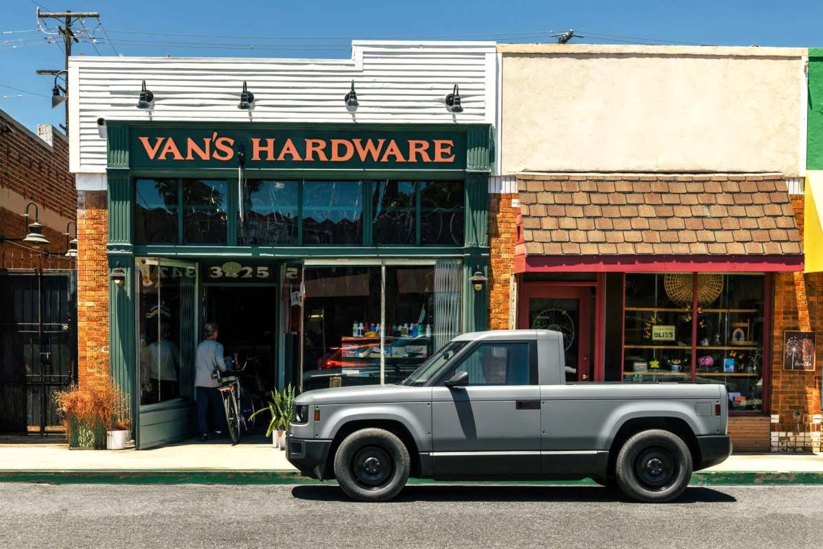A gray pickup truck parked in front of Van's Hardware store on a sunny day.
